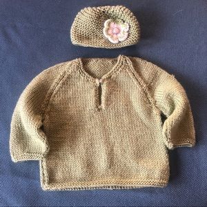 Hand-knit baby sweater with matching hat